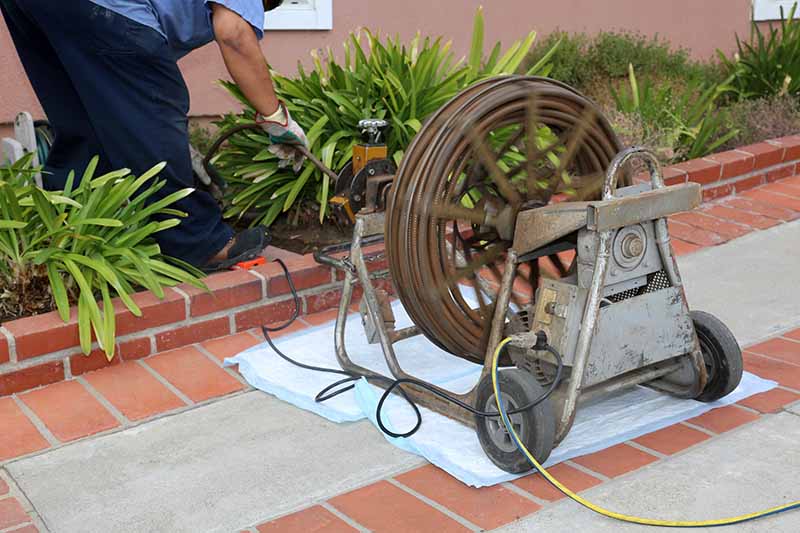 Sewer Camera Drain Snake Machine Setup Exterior sewer camera inspection drain snake cable reel machine setup outside home