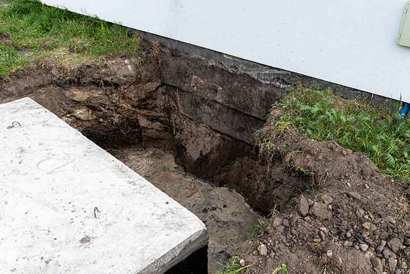 Foundation Excavation to Access Slab Leak Under Home excavation next to home foundation to access slab leak repair