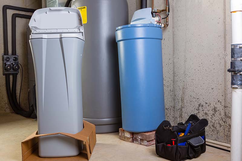 New Water Softener Units Staged for Installation new water softener and brine tank units staged in utility room before installation